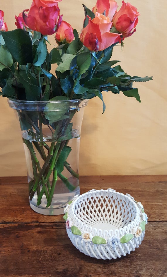 Artist made small white lattice bowl rimmed with pale roses Artist made small white lattice bowl rimmed with pale roses